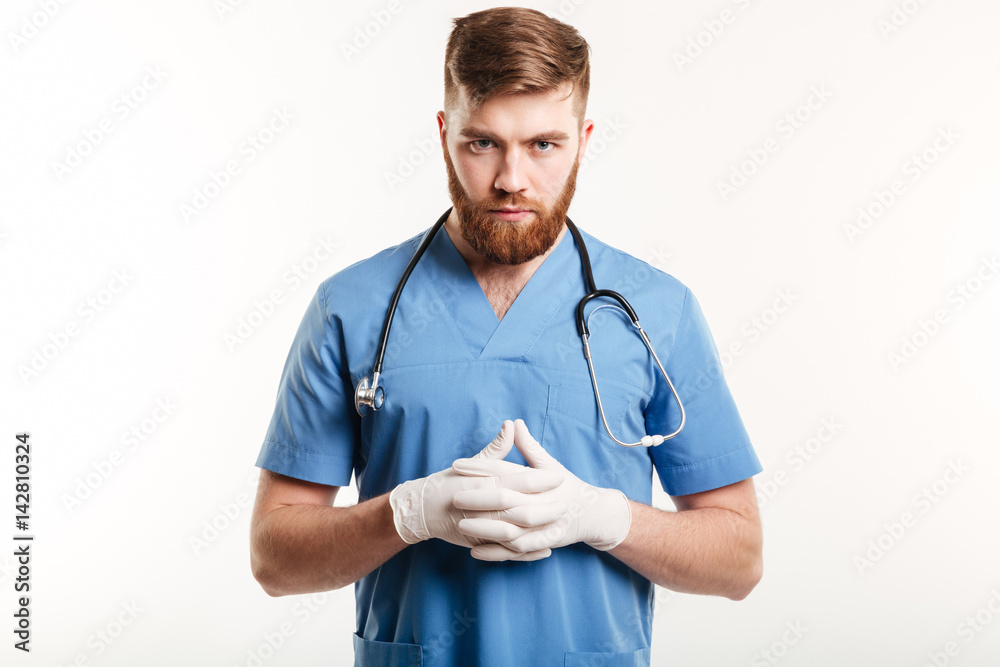 Portrait of a serious concentrated male medical doctor or nurse Portrait of a serious concentrated male medical doctor or nurse