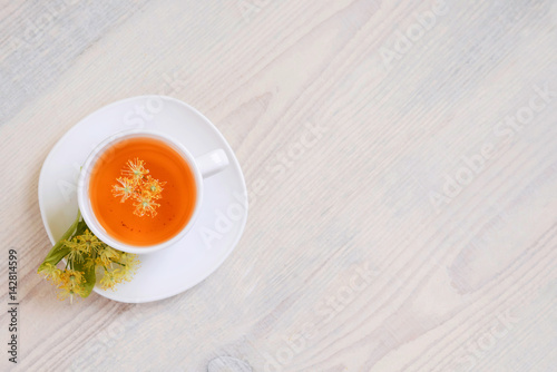 linden tea in a white cup on a light background, 