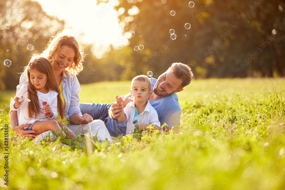 Fototapeta premium Children in nature make soap bubbles