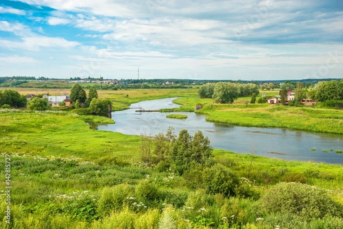 Rural summer landscape with a river bank