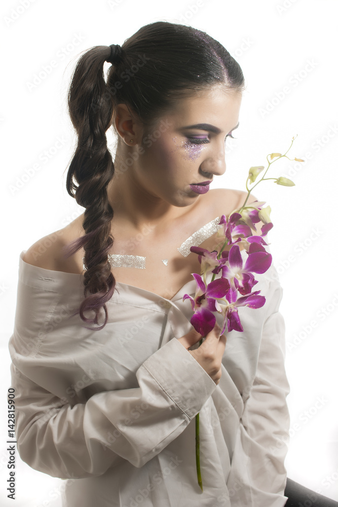 Portrait of a young girl with artistic make up and purple orchid Portrait of a young girl with artistic make up and purple orchid
