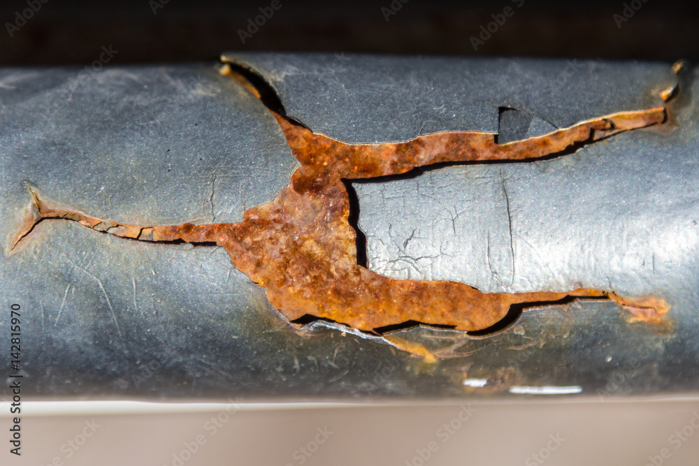 Fototapeta premium The rust on the pipe rinses the paint