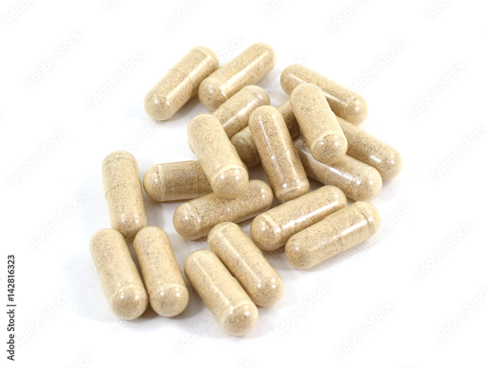 Drug capsule pills with beige medication in pile Drug capsule pills with beige medication in pile
