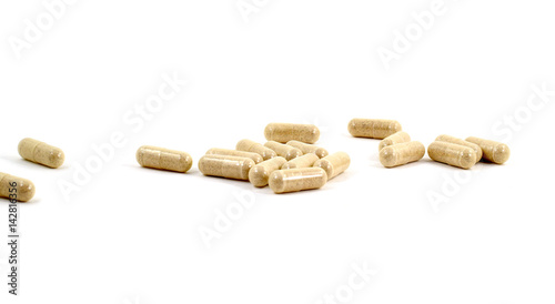 Drug capsule pills with beige medication in pile