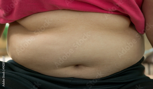 The fat woman pick the paunch with soft light.