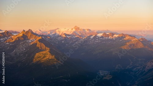 Warm light at sunrise on mountain peaks  ridges and valleys