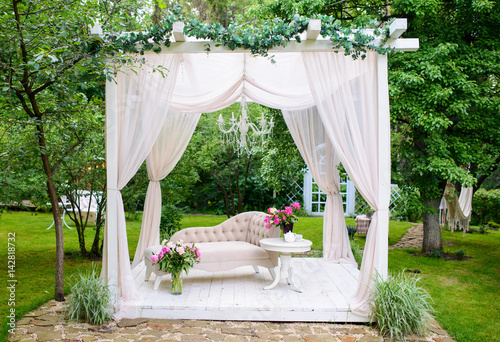 delicate elegant gazebo in lush gardens  photo