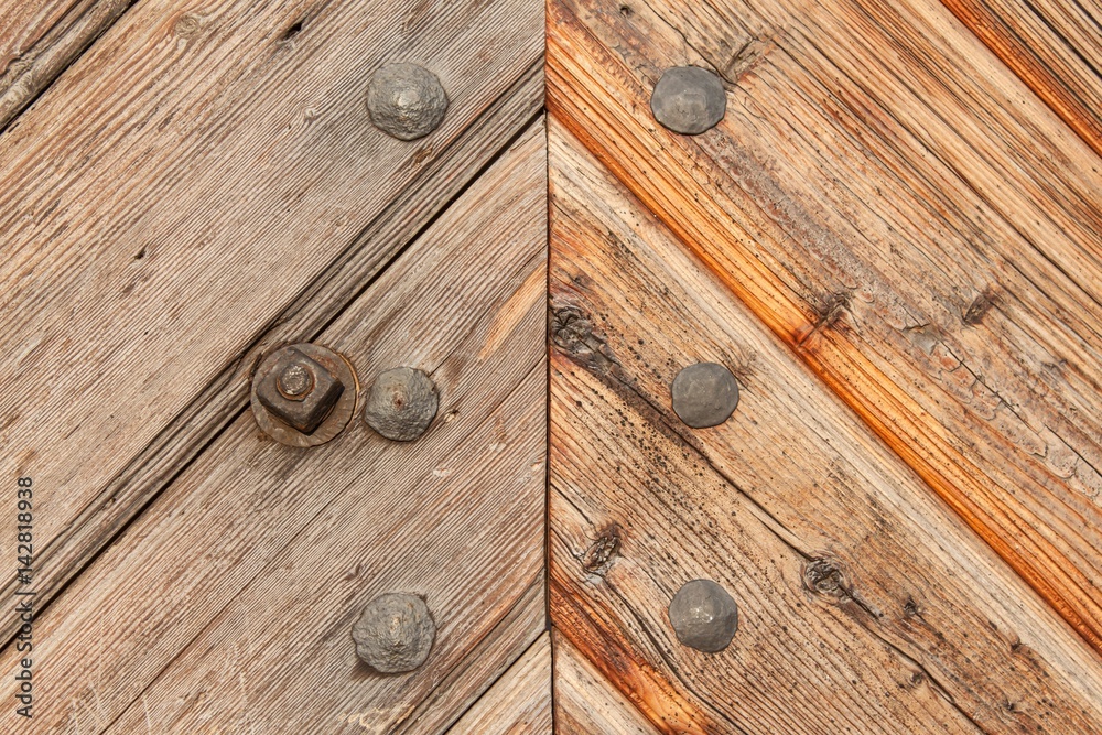 Old wooden boards with nails. Place for text. The wooden door of the castle. Old wooden boards with nails. Place for text. The wooden door of the castle.