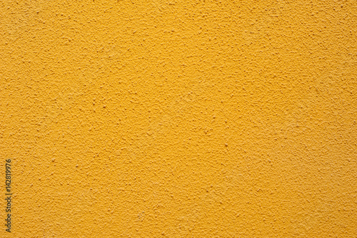 Texture of a textured yellow wall