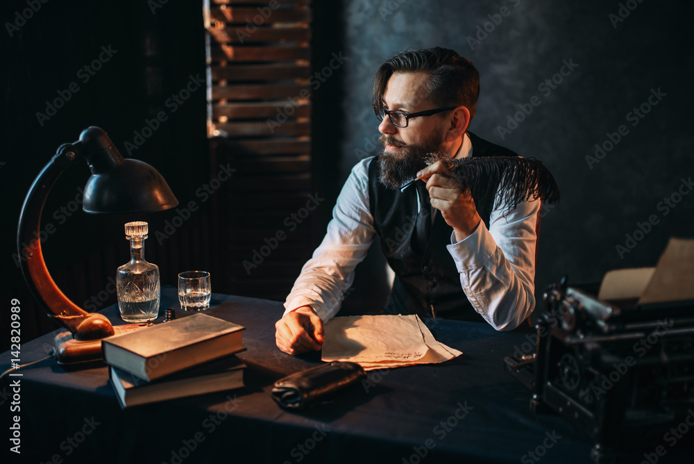 Bearded writer in glasses smoking a pipe - obrazy, fototapety, plakaty 