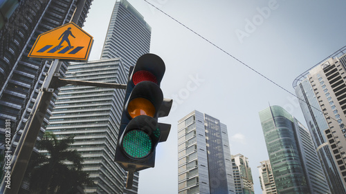 Photography Green traffic light in the city with yellow cross walk street sign and urban cityscape in background