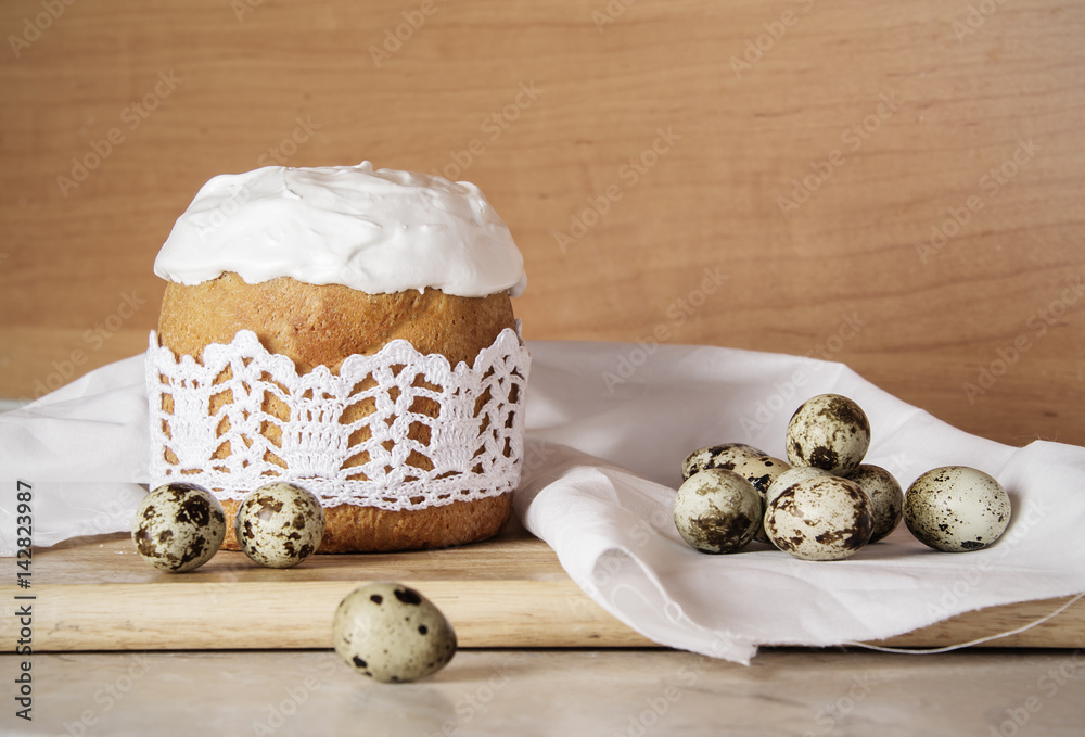 Easter wooden background with Easter cake and quail eggs