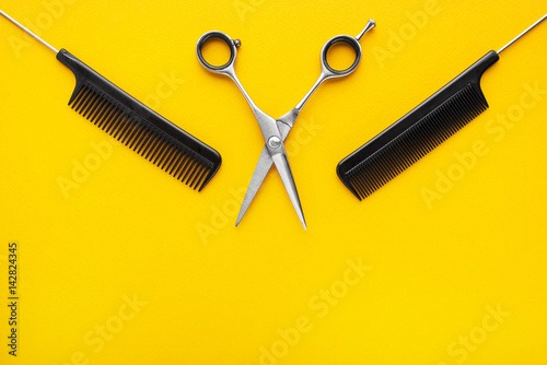 Hairdresser accessories on yellow background