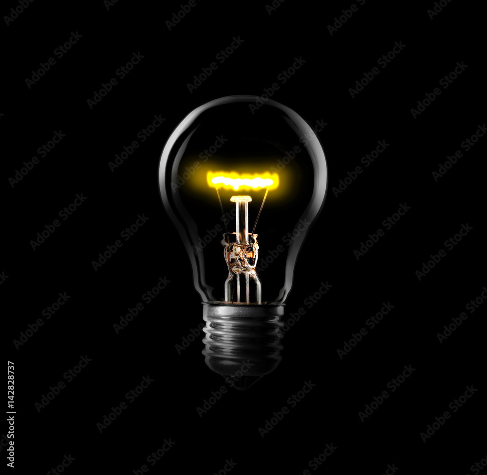 Light bulb turned on, black background. Light bulb turned on, black background.