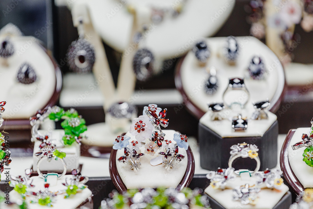 Set of luxury jewelry with precious gems and stones on a showcase of a shop Set of luxury jewelry with precious gems and stones on a showcase of a shop