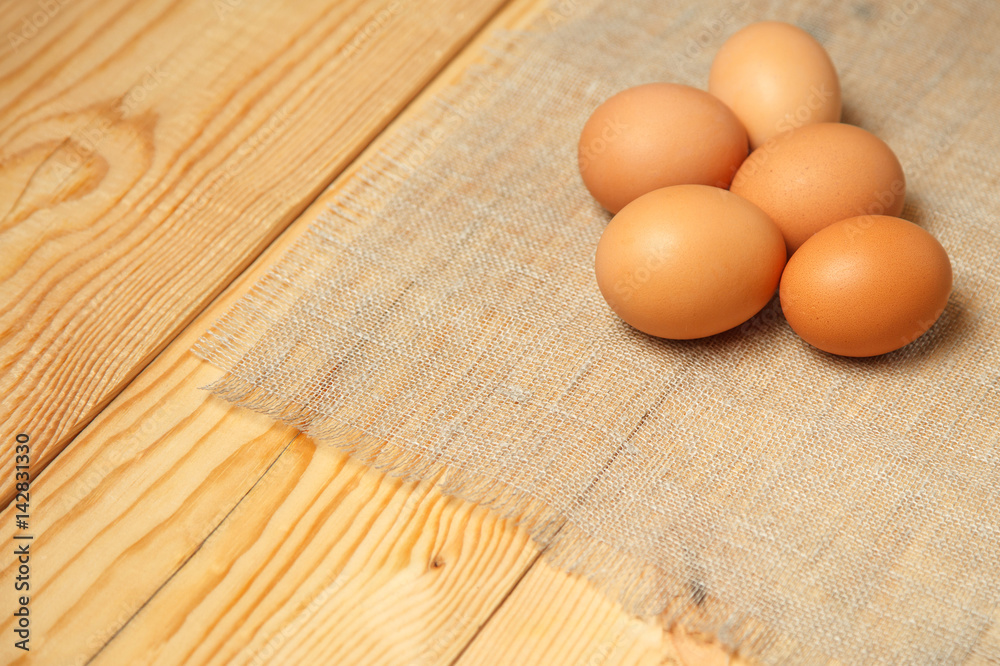 Fresh farm eggs on a wooden on wooden table Fresh farm eggs on a wooden on wooden table