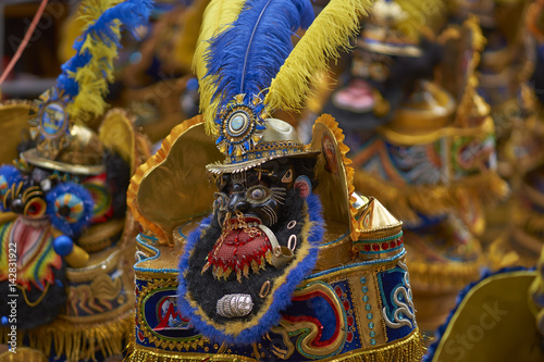 Morenada dancers in ornate costumes parade through the mining city of Oruro on the Altiplano of Bolivia during the annual carnival. photo