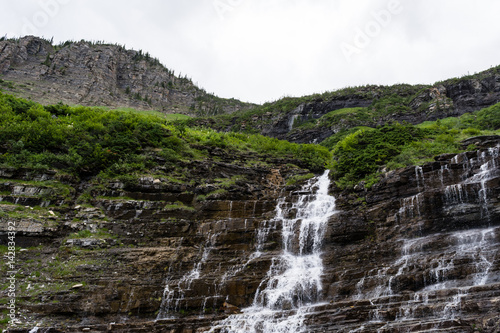 Weeping wall waterfall along Going-to-the-sun road in Glacier National Park, USA