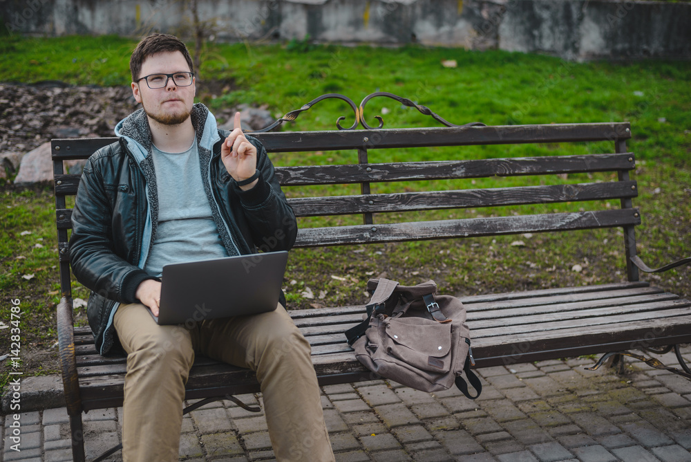 Fototapeta premium young modern businessman working in park
