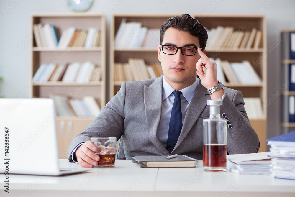 Businessman drinking in the office Businessman drinking in the office