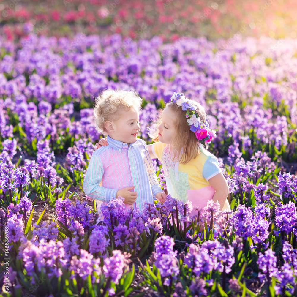 Kids playing in blooming garden with hyacinth flowers Kids playing in blooming garden with hyacinth flowers