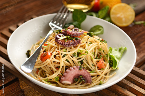 spaghetti with octopus  tomatoes and assorted herbs - Italian food