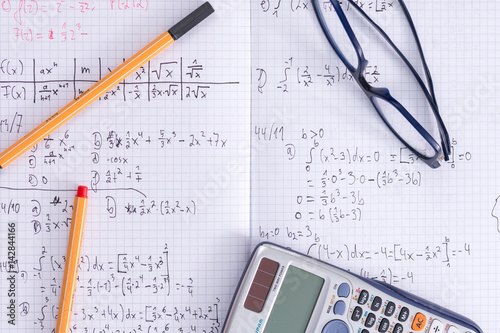 Maths school homework exercise book glasses calculator pens
