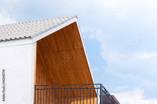 Wooden gabled roof with blue sky,triangles roof house sky background