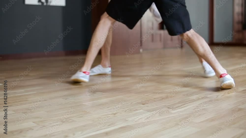 Legs of fighters in the spar are jumping on the floor in the training hall Legs of fighters in the spar are jumping on the floor in the training hall