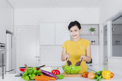 Casual woman cooking vegetables