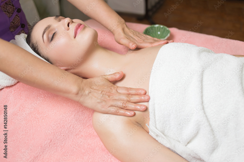 Portrait of woman patient in ayurveda spa wellness center lying relaxed on wood with aroma spa accessories. Young beautiful indian girl with ideal clean skin resting with closed eyes in beauty parlor. Portrait of woman patient in ayurveda spa wellness center lying relaxed on wood with aroma spa accessories. Young beautiful indian girl with ideal clean skin resting with closed eyes in beauty parlor.