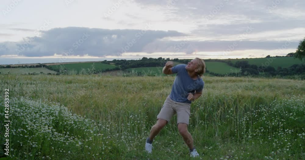 Happy dancer man dancing silly freestyle dance in open green field enjoying nature celebrating travel adventure Happy dancer man dancing silly freestyle dance in open green field enjoying nature celebrating travel adventure