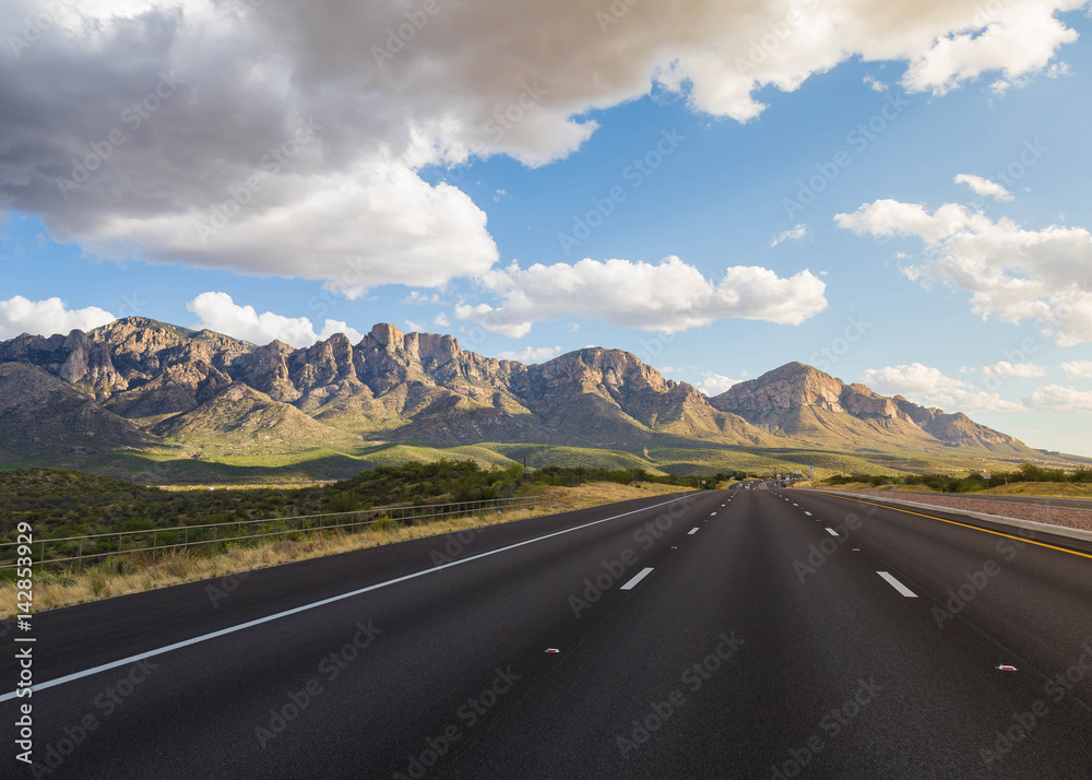 open road with mountain landscape during summer holidays are great for travel and wanderlust. road trip with beautiful american country scenery. escape into eternity with blue skies and golden clouds
