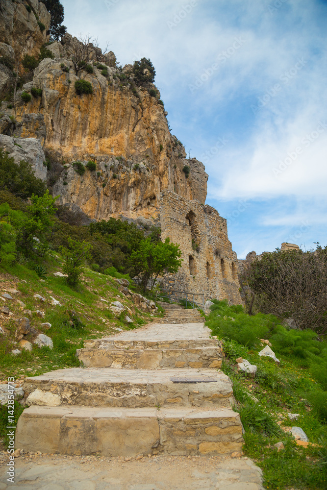 The Saint Hilarion Castle lies on the Kyrenia mountain range, in Cyprus. This location provided the castle with command of the pass road from Kyrenia to Nicosia. Beautiful Castle in the Mountains. The Saint Hilarion Castle lies on the Kyrenia mountain range, in Cyprus. This location provided the castle with command of the pass road from Kyrenia to Nicosia. Beautiful Castle in the Mountains.