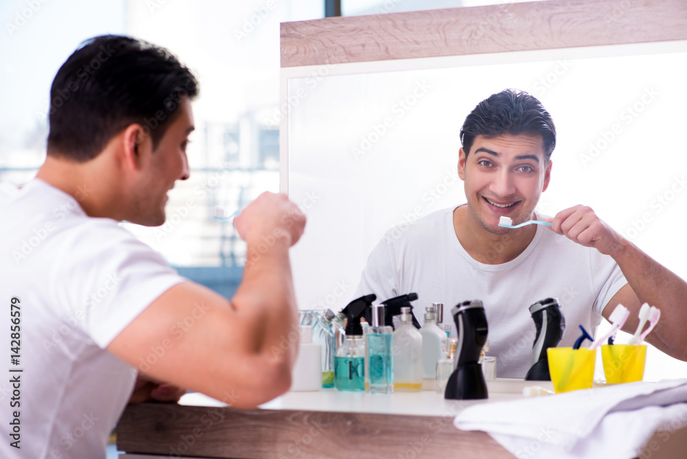 Handsome man brushing teeth in the morning Handsome man brushing teeth in the morning