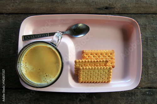 Travel to Doi Suthep, Chiangmai, Thailand. The cup of Thai coffee with cookies on the wooden background. photo