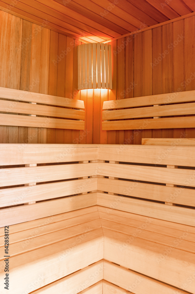 Sauna room. Wooden sauna interior with copper bucket. Bath accessories. Finnish sauna of small size. Sauna room. Wooden sauna interior with copper bucket. Bath accessories. Finnish sauna of small size.
