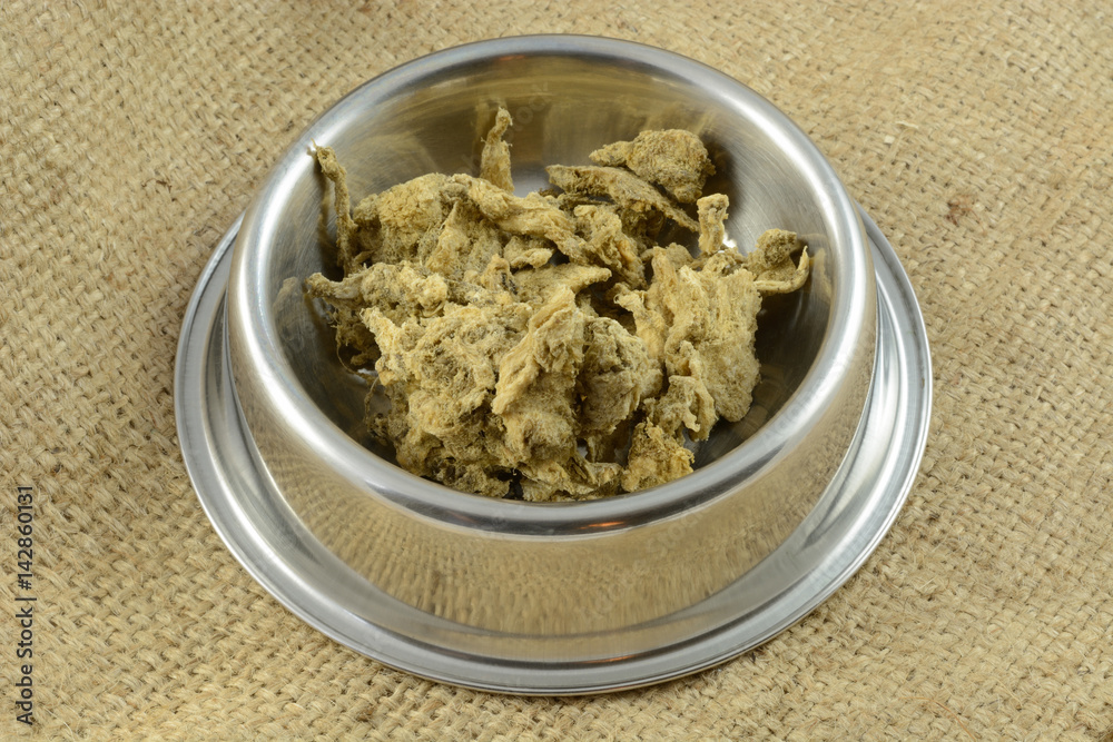 Dried crushed beef tripe dog or cat food and treat for dogs and cats in stainless steel pet bowl Dried crushed beef tripe dog or cat food and treat for dogs and cats in stainless steel pet bowl