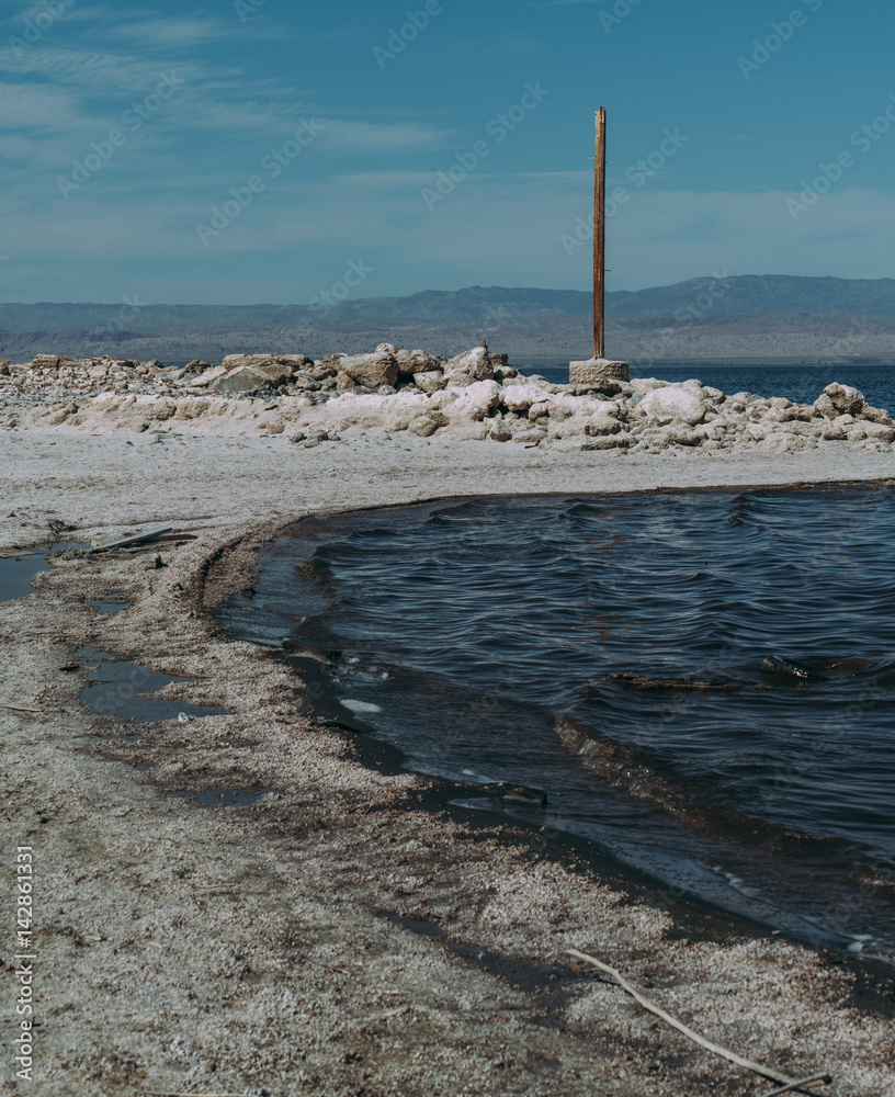 Salton Sea water landscape view, wooden pole, California Salton Sea water landscape view, wooden pole, California