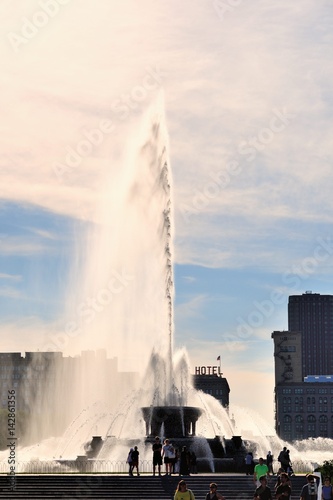 Backlighting illuminates the flowing spray on Chicago's Buckingham Fountain in Grant Park on a summer evening. The fountain was designed with sculptures by Jacques Lambert and was donated to the city.