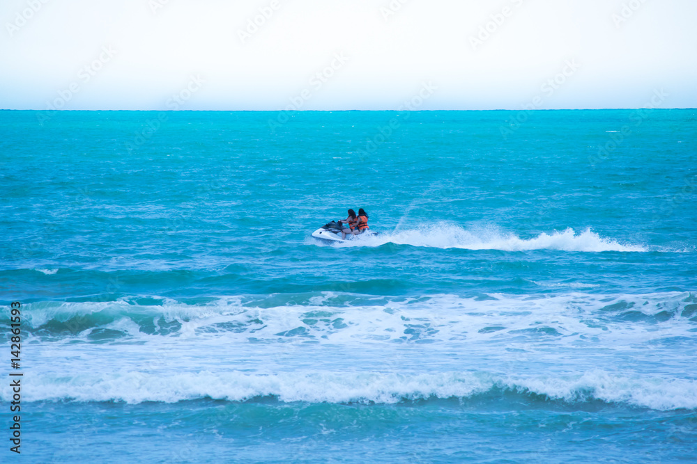Two girls enjoying speedboat at the beach