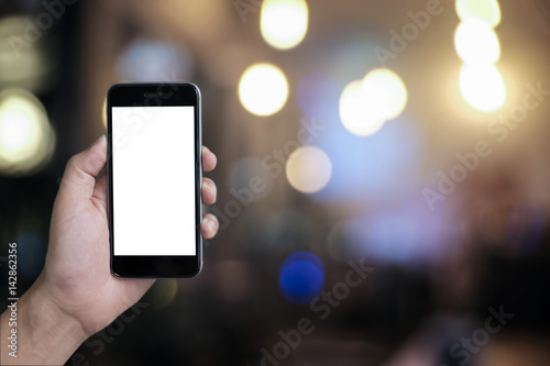 Close up of a man using smartphone with blank screen mobile and bokeh background.