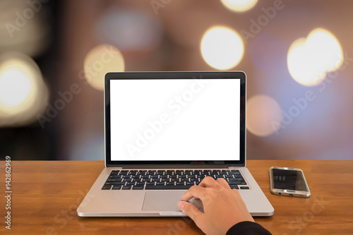 Young business women hand using laptop computer with blank screen and bokeh background and smartphone in home office