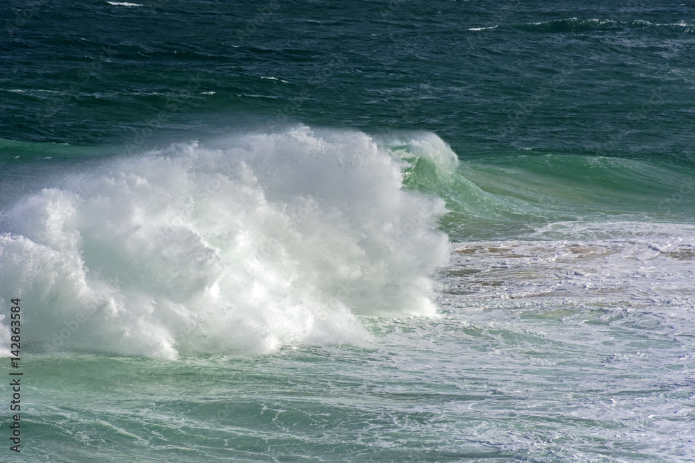 Wave crashing against rocks during storm Wave crashing against rocks during storm