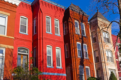 Historic urban architecture of Vernon Square neighborhood in Washington DC. Colorful residential row houses under bright afternoon sun.