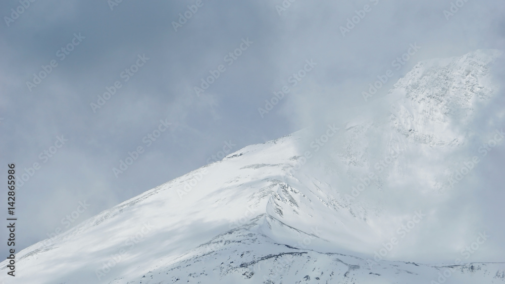 top of mountain covered with snow in National Park same level as cloud top of mountain covered with snow in National Park same level as cloud