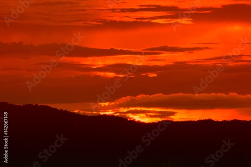 sunset in sky and cloud, beautiful colorful twilight time with mountain silhouette