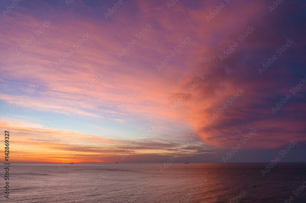 Beautiful sunrise, sunset sky over calm ocean