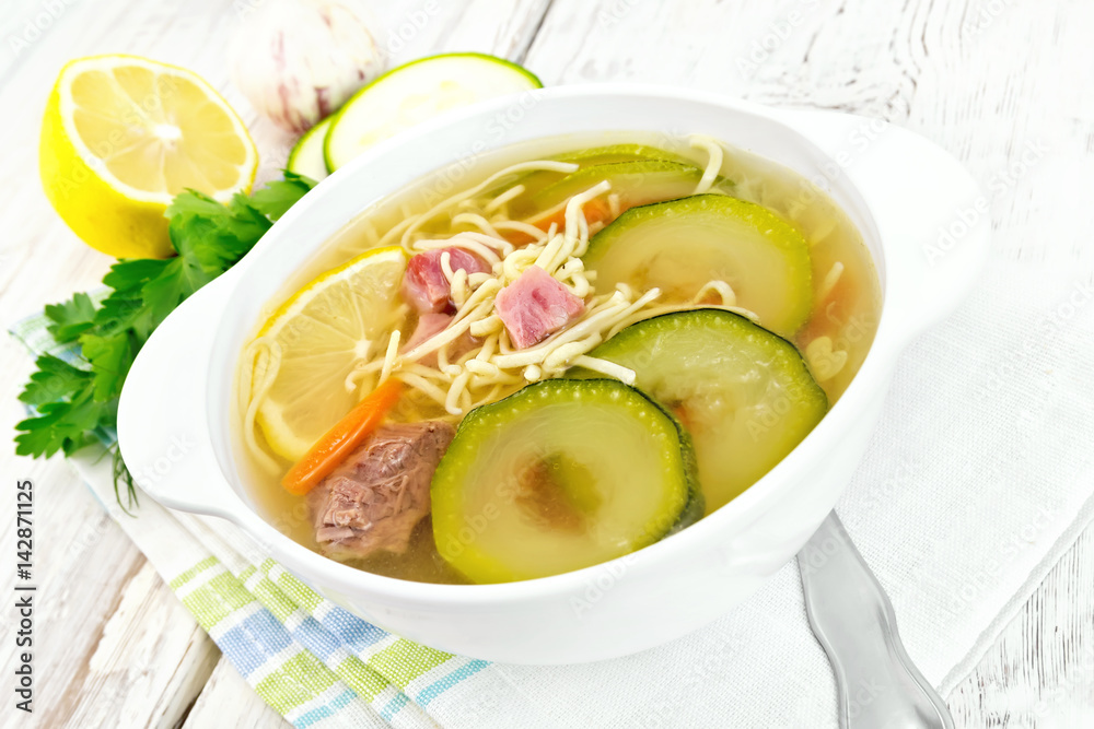 Soup with zucchini and noodles on board Soup with zucchini and noodles on board