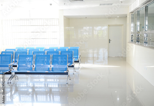 Hospital waiting room with empty chairs.